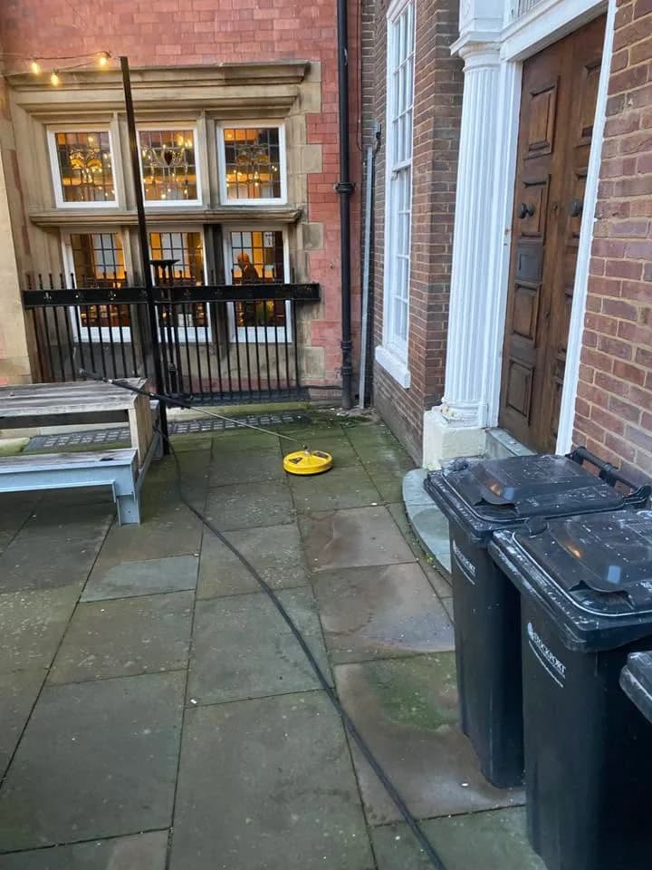 Dark marking across commercial entrance paving