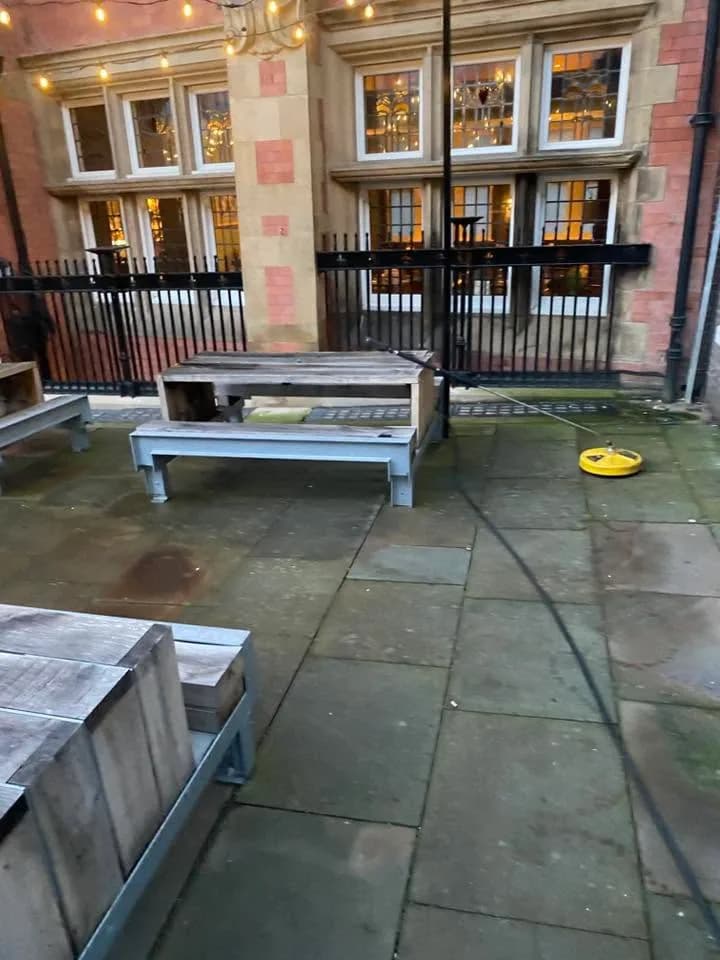 Commercial entrance paving being cleaned