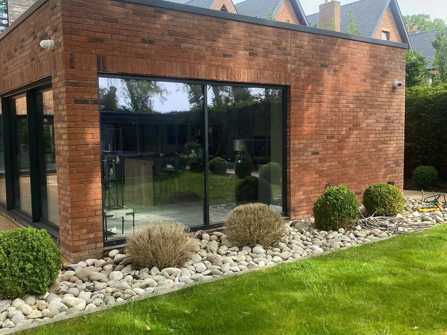 Clean brick exterior with stone landscaping